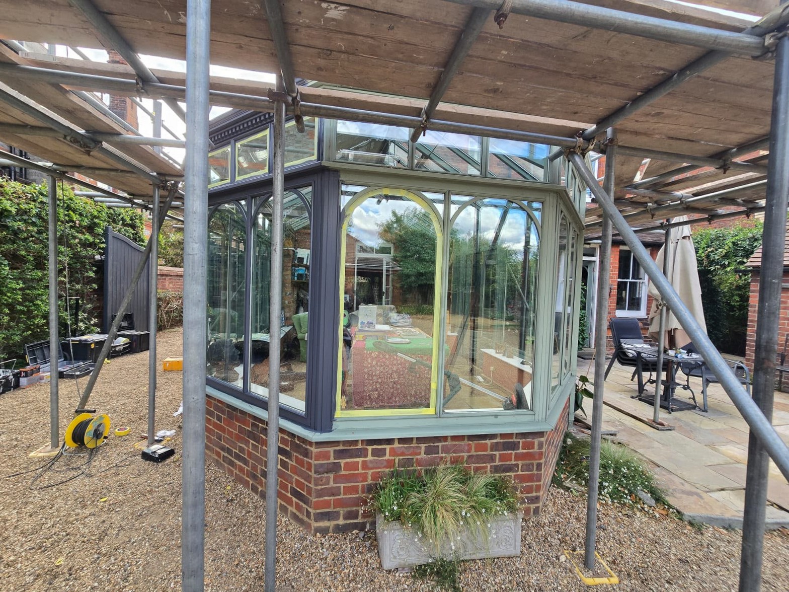 Conservatory frames being prepared and masked during restoration